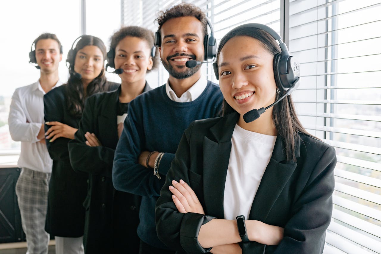 digital A diverse group of smiling call center agents in an office setting.